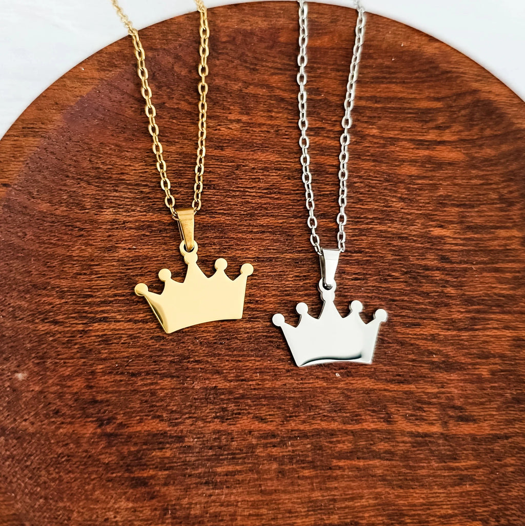 Roco Engraving gold and silver stainless steel crown pendants on an 18-inch chain with a polished mirror finish.