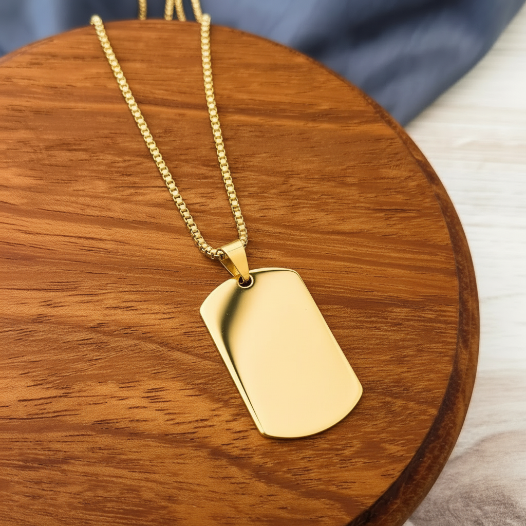 Roco Engraving gold stainless steel dog tag necklace with a smooth mirror finish on a wooden display stand