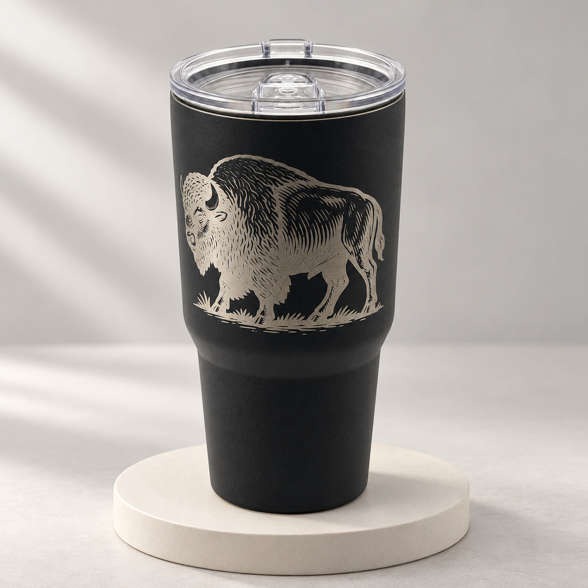 Black 30oz MakerFlo tumbler engraved with the Buffalo design, soft studio background