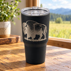 Black 30oz MakerFlo tumbler engraved with the Buffalo design, on a tabletop