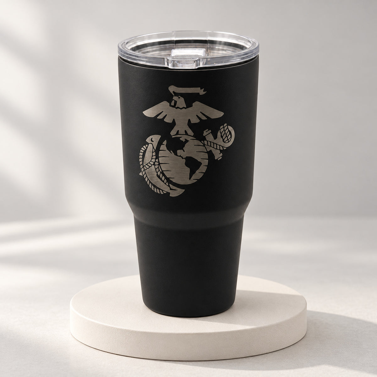 Black 30oz MakerFlo tumbler engraved with the Marines Emblem design, soft studio background