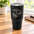 Black 30oz MakerFlo tumbler engraved with the Marines Emblem design, on a tabletop