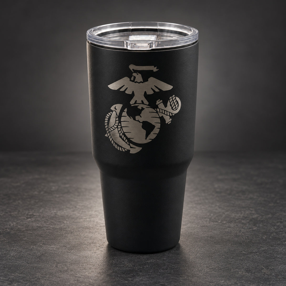Black 30oz MakerFlo tumbler engraved with the Marines Emblem design, studio lighting