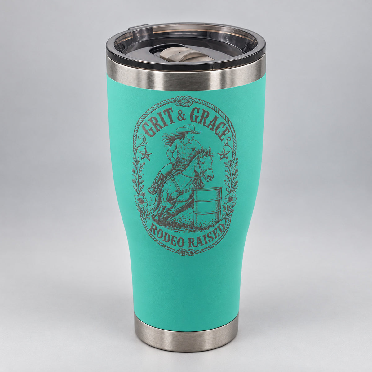 Teal 30oz HOGG Modern Curve tumbler engraved with the Grit & Grace design, studio close-up of the engraving