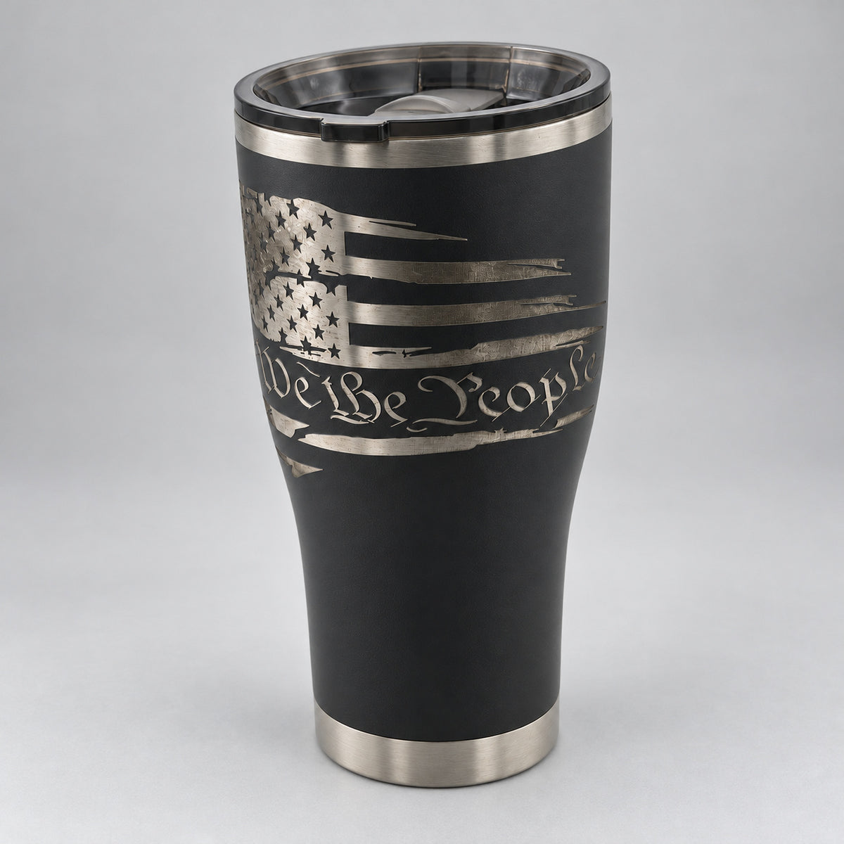 Black 30oz HOGG Modern Curve tumbler engraved with the We the People design, studio close-up of the engraving